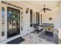 Cozy front porch with decorative door, ceiling fan, chair, swing and flagstone flooring at 332 William Falls Dr, Canton, GA 30114