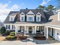 Charming home featuring a covered porch with classic columns and neat landscaping at 332 Williamfalls Dr, Canton, GA 30114