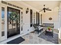 Inviting front porch with stylish decor, including a ceiling fan and comfortable seating at 332 Williamfalls Dr, Canton, GA 30114