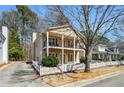 Inviting two-story home with double balconies, a manicured lawn and a white picket fence at 4612 Liberty Square Dr, Acworth, GA 30101