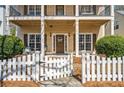 Inviting front entrance with a white picket fence, covered porch, and tasteful wreath on the door at 4612 Liberty Square Dr, Acworth, GA 30101
