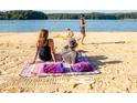 A Gathering enjoys a sunny day at the beach by a serene lake, swimming, relaxing, and playing games at 4755 Fowler St, Acworth, GA 30101