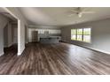 Open concept living room features hardwood floors, a ceiling fan and a kitchen with an island at 4755 Fowler St, Acworth, GA 30101