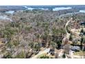 Scenic aerial view showcasing the property's proximity to a beautiful lake and lush surroundings at 5305 Pilgrim Point Rd, Cumming, GA 30041