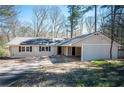Inviting ranch-style home featuring a convenient carport and classic design elements at 5305 Pilgrim Point Rd, Cumming, GA 30041