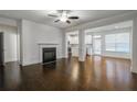 Bright living room with hardwood floors, fireplace, and an open floor plan leading to the kitchen at 5350 Brooklands Dr, Lithonia, GA 30058