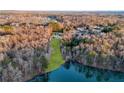 Secluded estate on a wooded lot with waterfront views and lush landscaping at 4233 Sandstone Shores Dr, Stonecrest, GA 30038