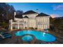 Backyard oasis featuring a large swimming pool, hot tub, and spacious patio at 4233 Sandstone Shores Dr, Stonecrest, GA 30038