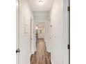 Hallway with hardwood floors, white doors and neutral paint at 46 Cooper Lake Sw Rd, Mableton, GA 30126