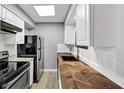 Cozy kitchen featuring white subway tile, stainless steel appliances and light wood floor at 117 Lablanc Nw Way, Atlanta, GA 30327