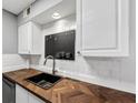 Kitchen sink with herringbone countertop and white cabinetry at 117 Lablanc Nw Way, Atlanta, GA 30327