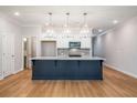 Bright kitchen with a large island, stainless steel appliances, and hardwood floors at 1604 Ruskin Way, Marietta, GA 30062