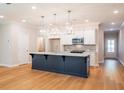 Bright kitchen with a large island, stainless steel appliances, and hardwood floors at 1604 Ruskin Way, Marietta, GA 30062