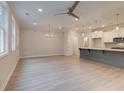 Open-concept living room and kitchen with hardwood floors and recessed lighting creating a relaxing atmosphere at 1604 Ruskin Way, Marietta, GA 30062