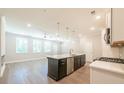 Stylish kitchen with a center island, modern appliances, and a seamless transition into the living area with hardwood floors at 1612 Ruskin Way, Marietta, GA 30062