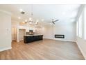 Open-concept layout with a modern fireplace, hardwood flooring, recessed lighting, and a clear view of the kitchen at 1612 Ruskin Way, Marietta, GA 30062