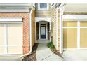 Inviting front entrance with covered porch between attached garages at 1670 Granville Ct, Lawrenceville, GA 30043