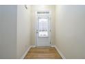 Bright entryway with hardwood floors and white door with window at 1670 Granville Ct, Lawrenceville, GA 30043