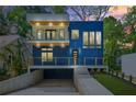 Modern home showcasing a striking blue exterior with a balcony and a well-manicured front yard at 237 Altoona Sw Pl, Atlanta, GA 30314