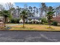 Beautiful two-story home with a manicured lawn and lush landscaping, including palm trees at 4970 Lakeland Woods Ct, Atlanta, GA 30338