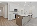 Modern kitchen with white cabinets, stainless appliances, and large island at 1624 Ruskin Way, Marietta, GA 30062
