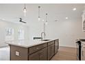 Open-concept kitchen with a large island, stainless steel appliances, and modern lighting at 1624 Ruskin Way, Marietta, GA 30062
