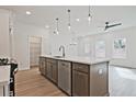 Bright kitchen featuring a central island, stainless steel appliances, and hardwood floors at 1624 Ruskin Way, Marietta, GA 30062