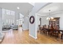 Elegant dining room featuring hardwood floors, tray ceilings, and a classic wooden dining table at 1657 Wilkinson Se Way, Smyrna, GA 30080