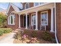 Inviting front porch with classic rocking chairs and blooming flowers at 1657 Wilkinson Se Way, Smyrna, GA 30080