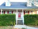 Inviting front porch featuring a decorative railing and a bright red front door at 345 Lambeth Dr, Hiram, GA 30141