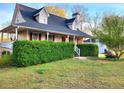 Charming home boasts manicured lawn, mature landscaping, and inviting front porch at 345 Lambeth Dr, Hiram, GA 30141