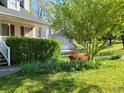 Lush front yard landscaping featuring beautiful flowers and mature trees at 345 Lambeth Dr, Hiram, GA 30141