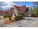 Attractive home showcasing a brick facade, well-kept landscaping, and a driveway leading to a garage at 5 Coventry Close, Avondale Estates, GA 30002
