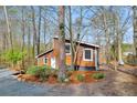 Charming home nestled in a wooded area, featuring a distinctive facade at 279 Alex St, Canton, GA 30114