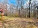 Expansive backyard featuring mature trees, offering privacy and space for outdoor activities at 3520 Newberry Ln, Douglasville, GA 30135