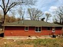 Rear view of the brick home highlighting the windows and backyard with room for outdoor living at 2143 Rhinehill Se Rd, Atlanta, GA 30315