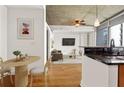 Open-concept living area boasts a sleek modern kitchen with black countertops and a cozy dining nook at 44 Peachtree Nw Pl # 1328, Atlanta, GA 30309