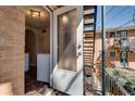 Exterior entry with a partially-frosted glass door, brick flooring and metal stairs at 3510 Nw Roswell Nw Rd # J1, Atlanta, GA 30305