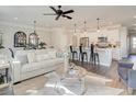 Open concept living area with kitchen island, bright white cabinets, and modern decor at 4527 Moray Dr, Mableton, GA 30126