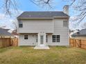 The back exterior of the house features neutral siding, a fenced yard, and a door leading to the outside at 7006 Mahonia Pl, Lithonia, GA 30038