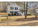 White split level home with a welcoming porch and mature trees dotting the front yard at 673 Waters Rd, Hiram, GA 30141