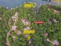 Aerial view of the property with a golf cart path and private boat dock, surrounded by lush green trees and lake at 7640 Harbour Walk, Cumming, GA 30041