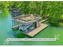 This lake home includes a private boat dock with an upper deck and boat slip, offering serene waterfront living at 7640 Harbour Walk, Cumming, GA 30041
