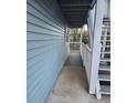 Exterior view of a light blue, covered balcony with white railings and stair access at 1644 Alexandria Ct, Marietta, GA 30067