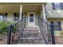 Inviting front porch with stone steps and iron railings, leading to the entrance of the home at 1767 Wingard Dr, Marietta, GA 30062