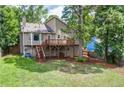 Expansive backyard view featuring a spacious deck, lush green lawn, and mature trees at 3260 Sims View Ct, Snellville, GA 30078