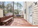 Wooden back deck featuring a bench, perfect for enjoying the outdoors, with trees and foliage surrounding the property at 34 Kelso At Peyton Dr, Atlanta, GA 30311