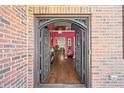 View of the foyer through the ornate wrought iron double doors, with hardwood floors and interior design at 3316 Quarter Horse Ln, Conyers, GA 30013