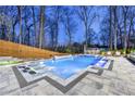 Backyard pool featuring lounge chairs, a spa, and a surrounding fence at 4080 Glen Hill Ne Way, Marietta, GA 30066