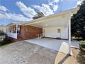 Covered carport showcasing access to the house through a white door and a ramp for accessibility at 248 Arnold Ave, Marietta, GA 30066